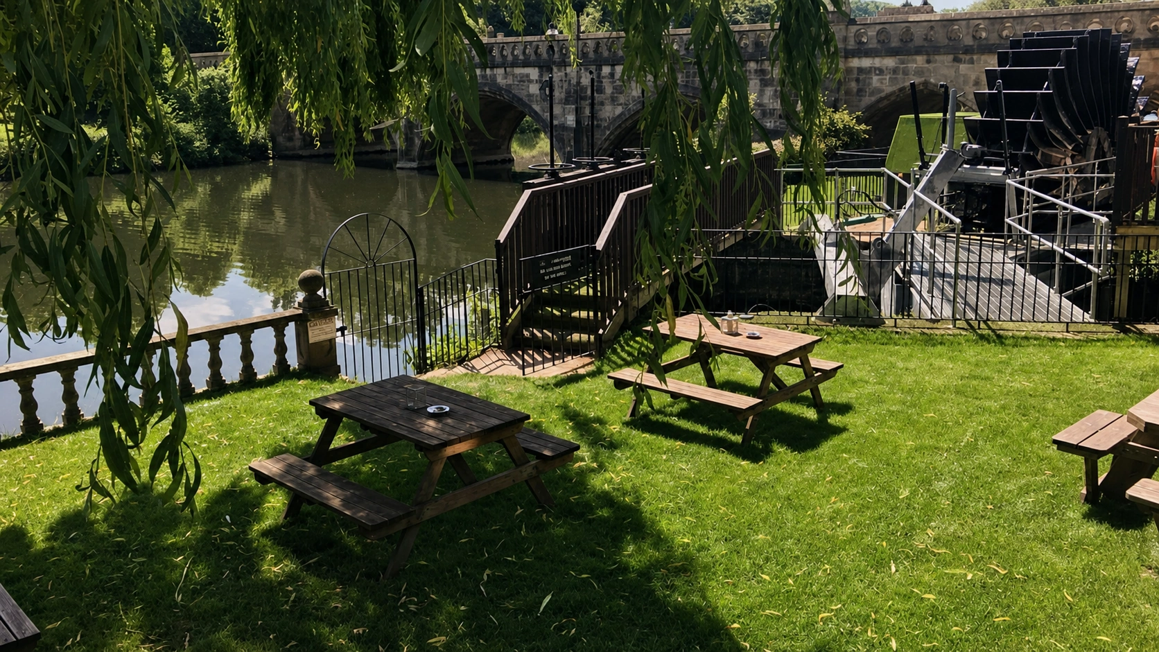 Riverside garden and historic water wheel at Il Mulino