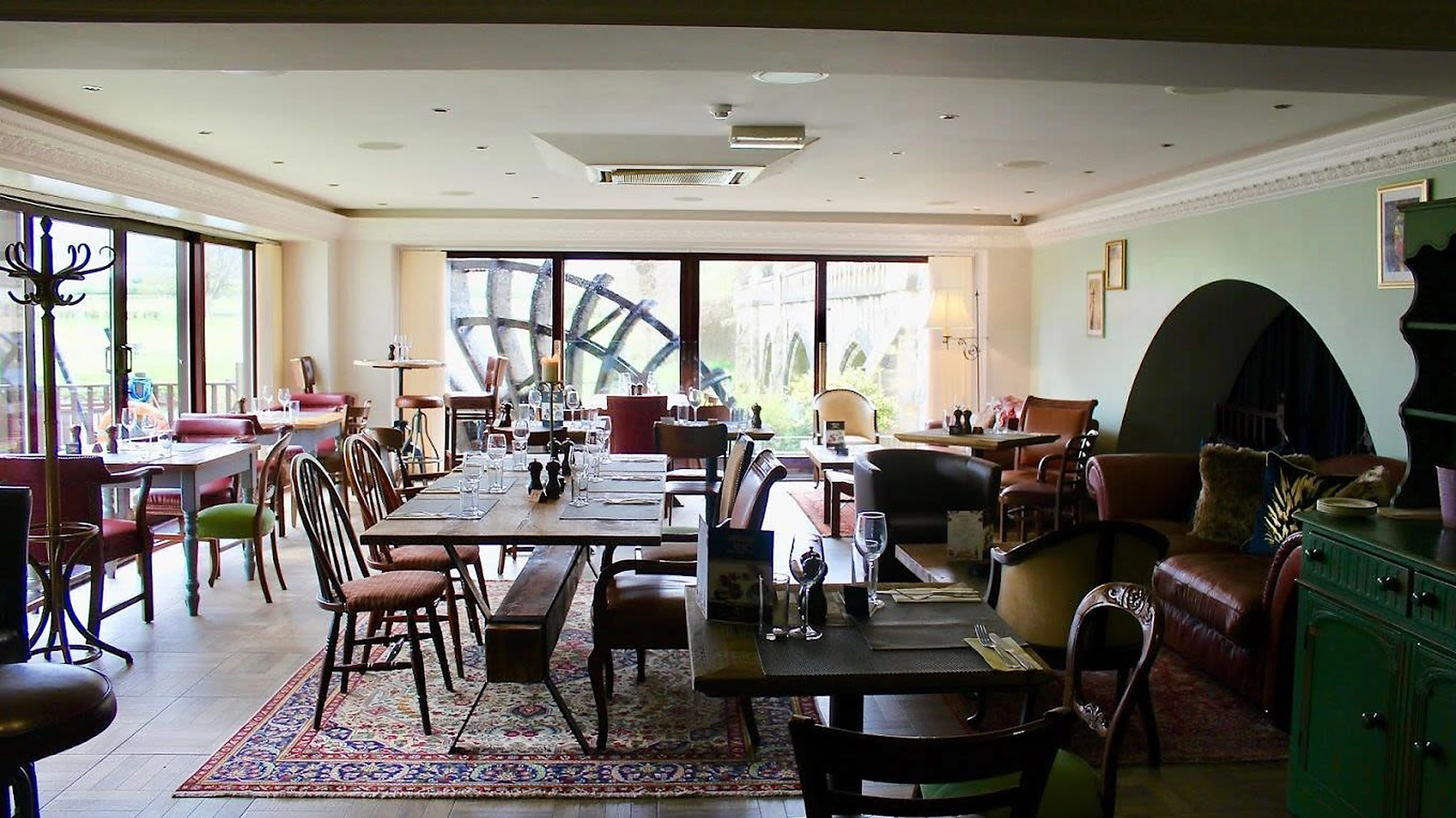 Bright Il Mulino dining room with the water wheel outside